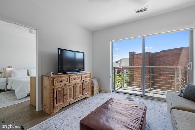 living room with baseboards, visible vents, and plenty of natural light