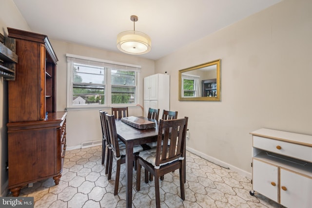 dining area featuring baseboards