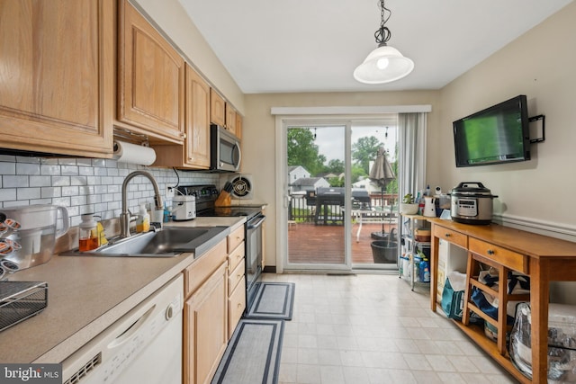 kitchen featuring black electric range, stainless steel microwave, a sink, white dishwasher, and decorative backsplash