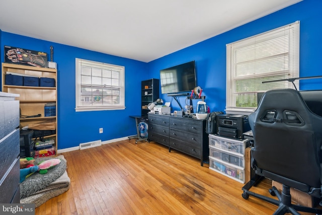 office area with hardwood / wood-style floors and baseboards