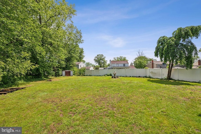 view of yard with a shed, an outdoor structure, and central AC