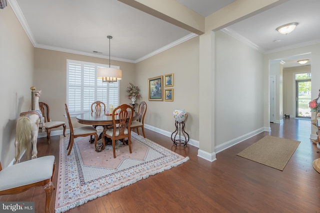 dining area with crown molding, baseboards, visible vents, and wood finished floors