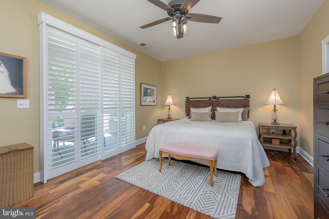 bedroom featuring baseboards, wood finished floors, and visible vents