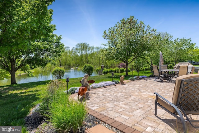 view of patio / terrace with a water view and outdoor dining space