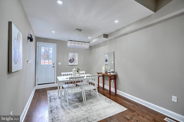 dining space with a notable chandelier, baseboards, dark wood finished floors, and recessed lighting