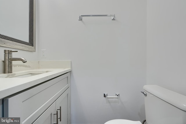 bathroom featuring toilet and vanity