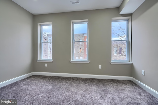 unfurnished room with carpet floors, baseboards, and plenty of natural light