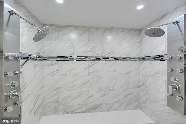 full bathroom featuring recessed lighting and tiled shower