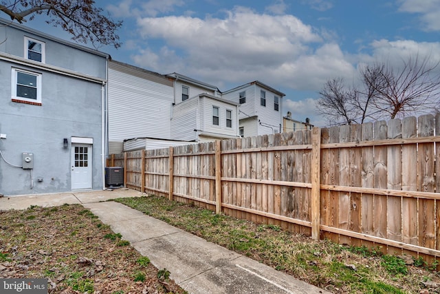 view of yard with fence and central AC unit