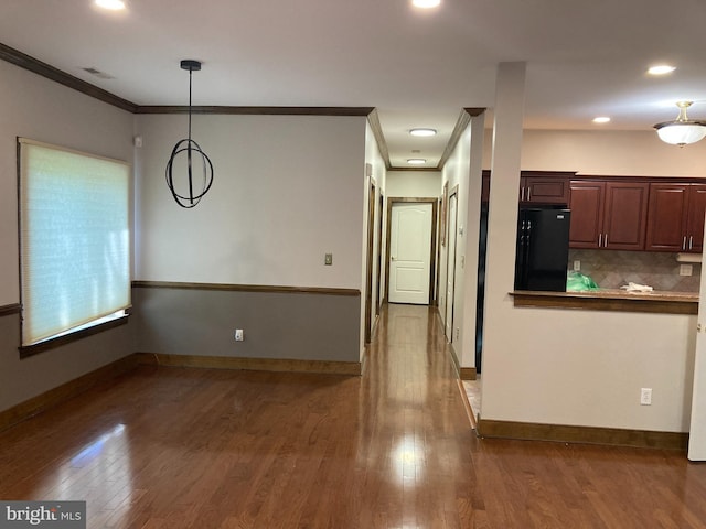 1630 Welsh Rd Unit 49G, Philadelphia, PA 19115 - kitchen with crown molding, black fridge, wood finished floors, and visible vents