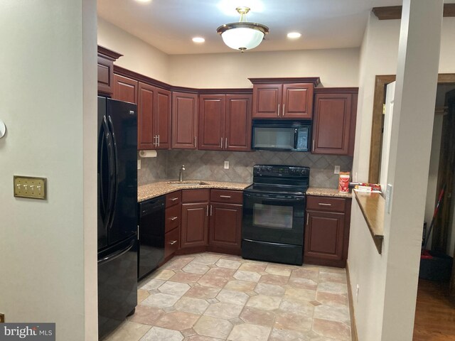 1630 Welsh Rd Unit 49G, Philadelphia, PA 19115 - kitchen with light stone counters, a sink, black appliances, and tasteful backsplash