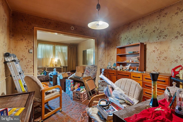 living area with carpet floors and wallpapered walls