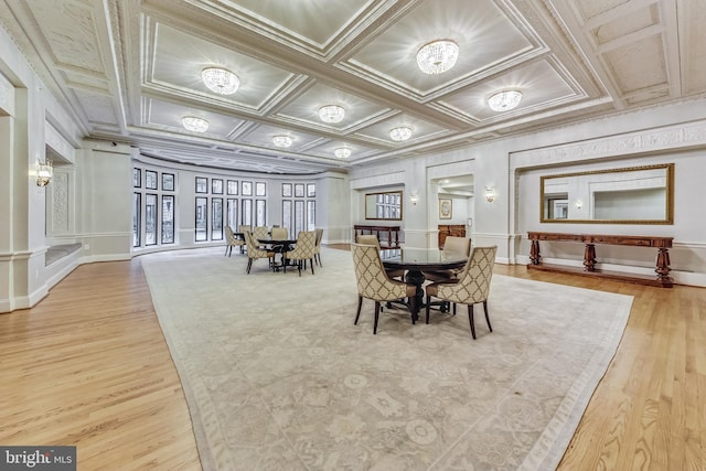 dining area with ornate columns, coffered ceiling, and wood finished floors