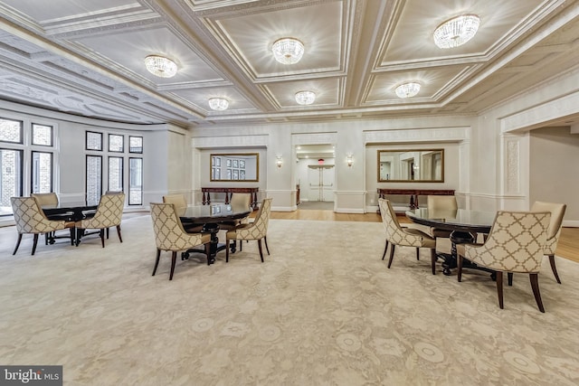 dining room with crown molding, coffered ceiling, and a decorative wall