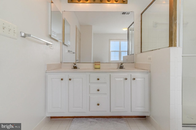 9116 Mineola Ct, Manassas, VA 20111 - full bathroom with tile patterned floors, double vanity, an enclosed shower, and baseboards