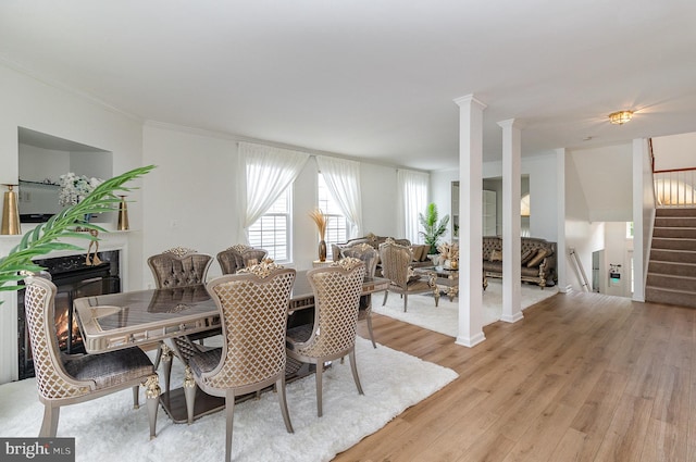 9116 Mineola Ct, Manassas, VA 20111 - dining space featuring stairs, light wood-type flooring, ornamental molding, and ornate columns