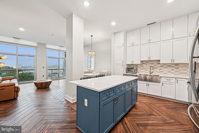 2772 Lighthouse Pt E Unit 410, Baltimore, MD 21224 - kitchen featuring blue cabinetry, open floor plan, white cabinetry, and recessed lighting