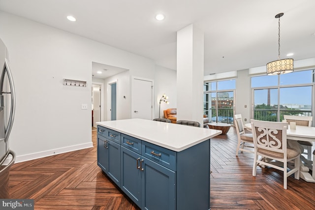 2772 Lighthouse Pt E Unit 410, Baltimore, MD 21224 - kitchen with blue cabinets, hanging light fixtures, light countertops, a kitchen island, and recessed lighting