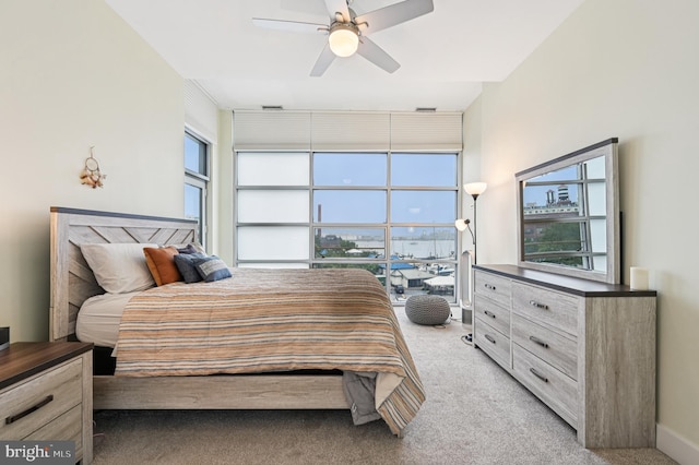 2772 Lighthouse Pt E Unit 410, Baltimore, MD 21224 - bedroom with light colored carpet and a ceiling fan