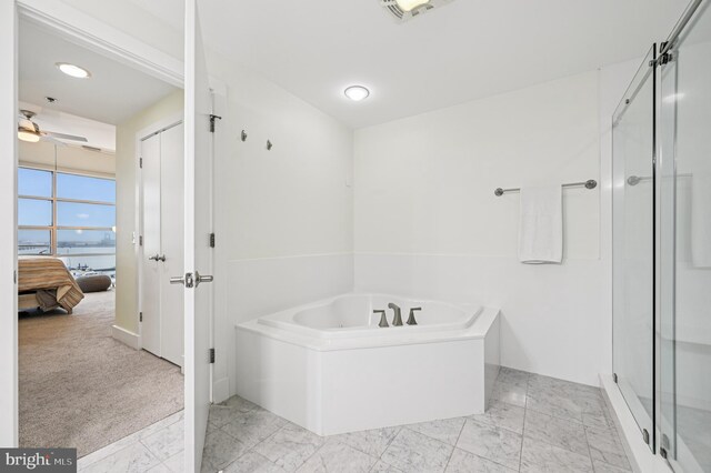 2772 Lighthouse Pt E Unit 410, Baltimore, MD 21224 - full bathroom featuring a garden tub, a ceiling fan, ensuite bathroom, a stall shower, and a water view