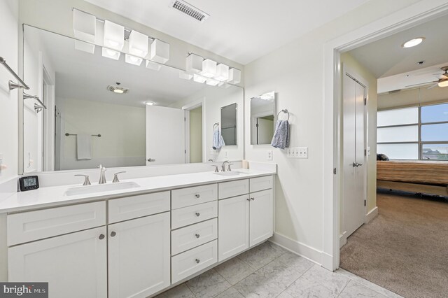 2772 Lighthouse Pt E Unit 410, Baltimore, MD 21224 - ensuite bathroom featuring double vanity, ceiling fan, and marble finish flooring