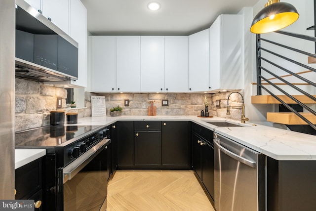 609 S Orianna St Unit 1, Philadelphia, PA 19147 - kitchen featuring dark cabinetry, a sink, white cabinetry, and appliances with stainless steel finishes