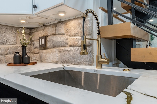 609 S Orianna St Unit 1, Philadelphia, PA 19147 - room details with white cabinets, light stone counters, and a sink