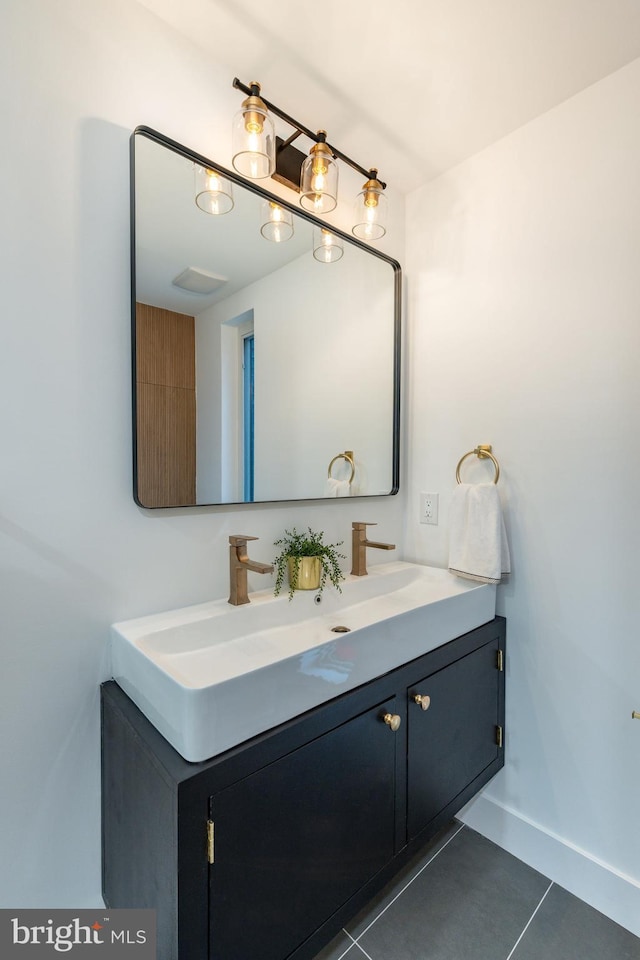 609 S Orianna St Unit 1, Philadelphia, PA 19147 - bathroom with double vanity, tile patterned floors, and baseboards