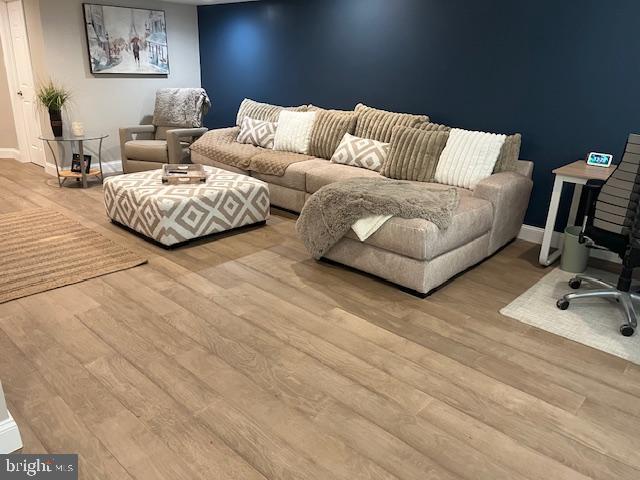 living room with baseboards and wood finished floors