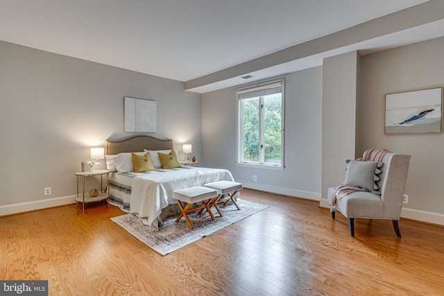 bedroom with light wood-style floors and baseboards