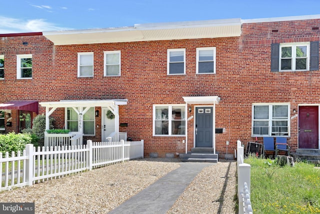 multi unit property with brick siding, fence, and crawl space