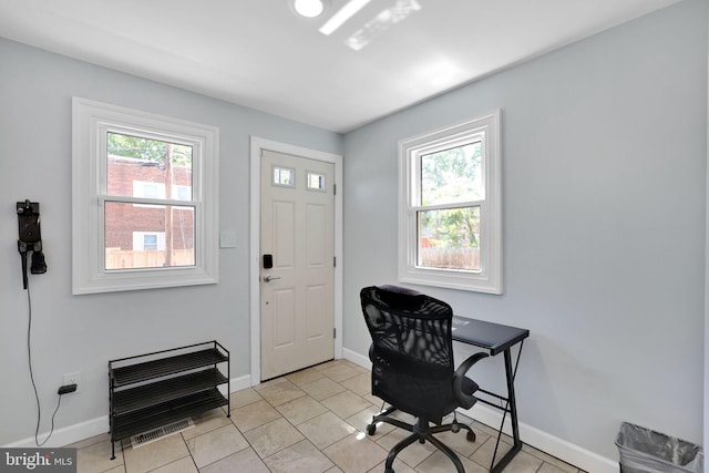 home office with baseboards, heating unit, and light tile patterned floors