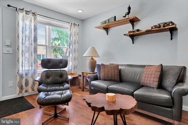 living room featuring baseboards and wood finished floors