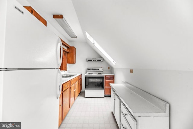 kitchen featuring white appliances, light floors, light countertops, ventilation hood, and a skylight