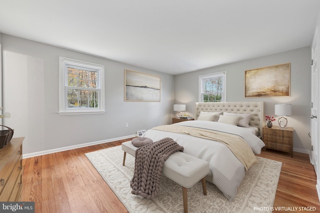 bedroom with baseboards and wood finished floors