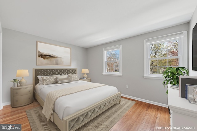 bedroom featuring baseboards and light wood-style floors