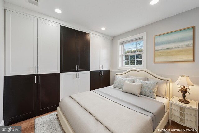 bedroom featuring recessed lighting, visible vents, and wood finished floors