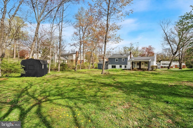 view of yard featuring an outbuilding and a storage unit
