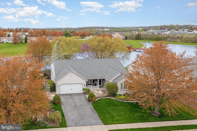 birds eye view of property with a water view