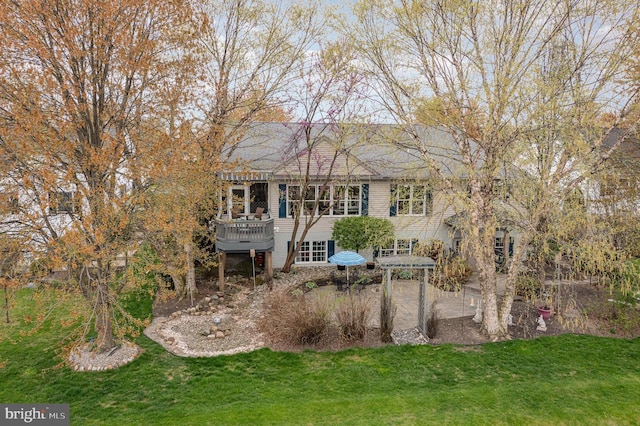 back of house with a yard and a deck