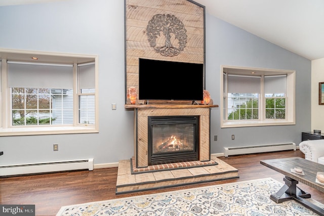 living room featuring a glass covered fireplace, a baseboard radiator, wood finished floors, and lofted ceiling