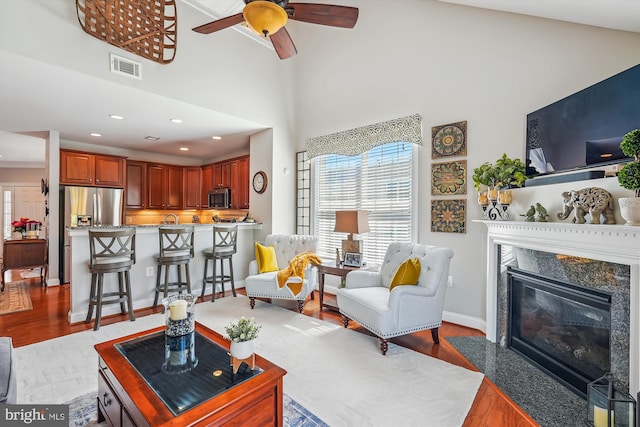 44451 Cruden Bay Dr, Ashburn, VA 20147 - living room with visible vents, wood finished floors, recessed lighting, a ceiling fan, and a premium fireplace