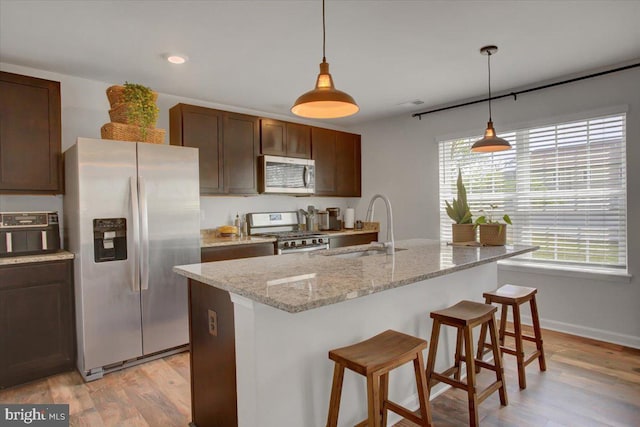 11174 Cross Fields Dr, Waynesboro, PA 17268 - kitchen featuring a sink, appliances with stainless steel finishes, a breakfast bar, and light wood-style floors