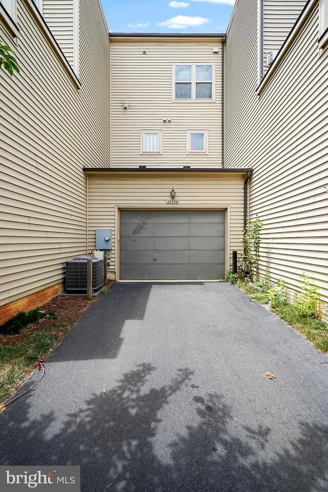 22788 Sagamore Sq, Brambleton, VA 20148 - garage with central AC unit and aphalt driveway