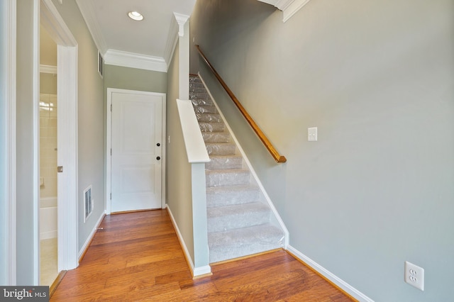 22788 Sagamore Sq, Brambleton, VA 20148 - staircase featuring wood finished floors, visible vents, recessed lighting, crown molding, and baseboards