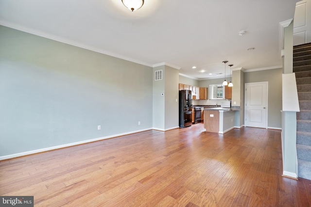 22788 Sagamore Sq, Brambleton, VA 20148 - unfurnished living room featuring baseboards, ornamental molding, visible vents, stairs, and wood finished floors