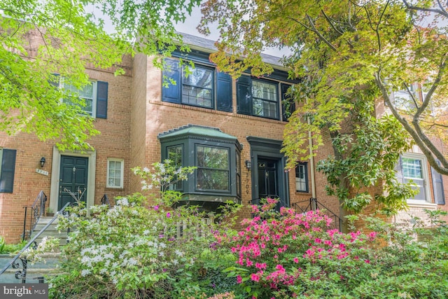 view of front of house featuring brick siding
