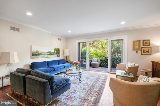 living area featuring recessed lighting, visible vents, ornamental molding, and wood finished floors