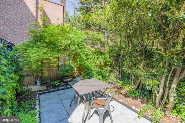 view of patio with outdoor dining area and fence