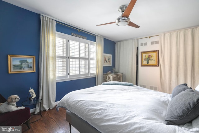 bedroom with visible vents, ceiling fan, and wood finished floors